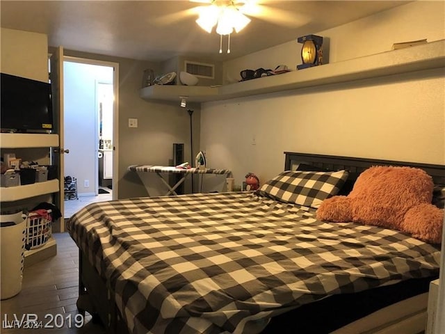 bedroom with ceiling fan and dark wood-type flooring