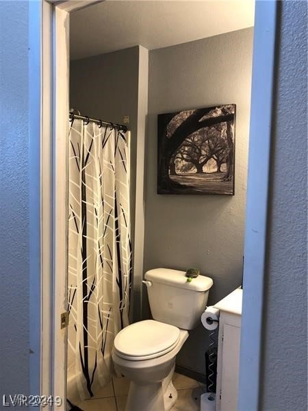 bathroom featuring tile patterned floors and toilet