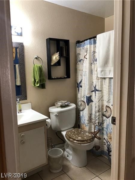 bathroom featuring toilet, vanity, and tile patterned floors