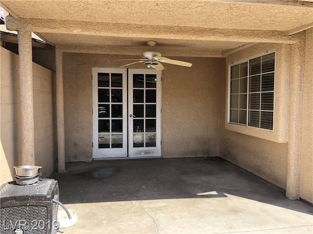 property entrance with ceiling fan, a patio area, and french doors