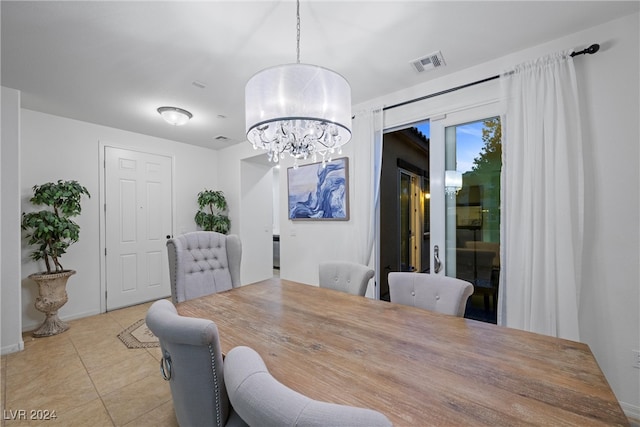 dining room featuring light tile patterned floors and a chandelier