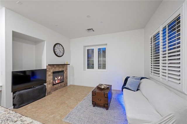 living room with a tile fireplace