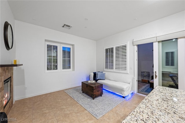 tiled bedroom featuring a tile fireplace