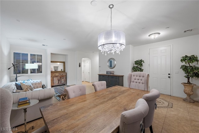 dining room with a chandelier and light tile patterned flooring