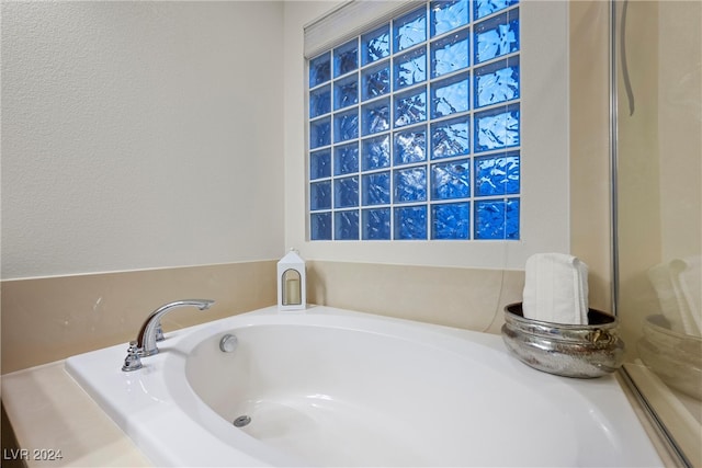 bathroom featuring a tub to relax in