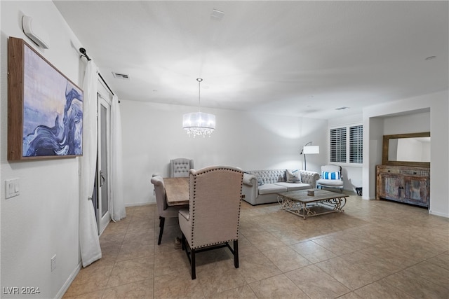 dining room featuring light tile patterned floors and a notable chandelier