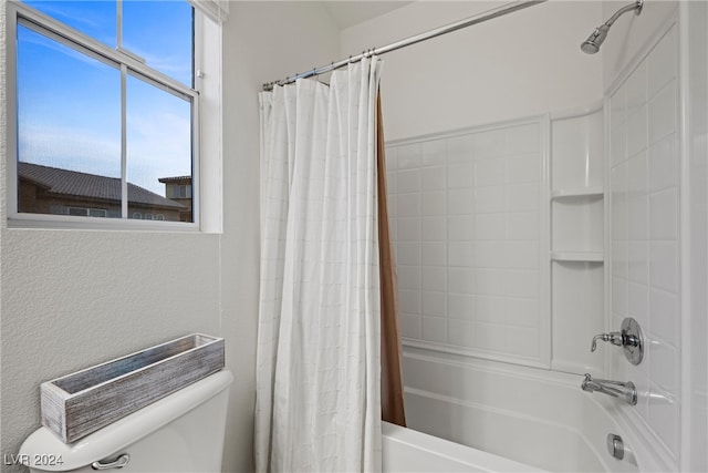 bathroom with shower / bath combination with curtain