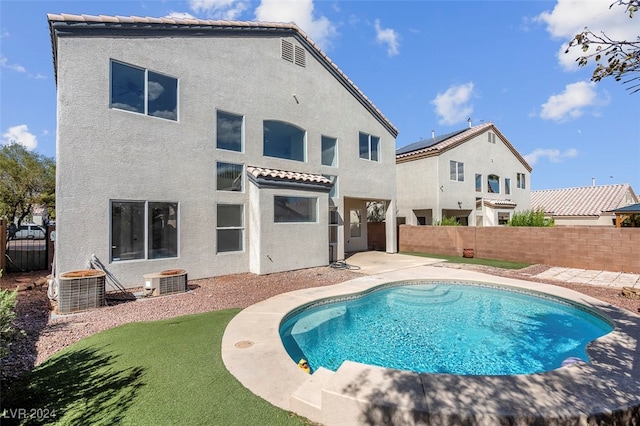 view of pool featuring cooling unit and a patio area