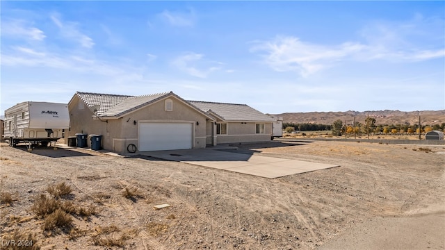 view of front of home with a mountain view and a garage