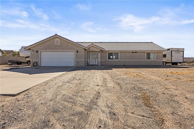 ranch-style home featuring a garage