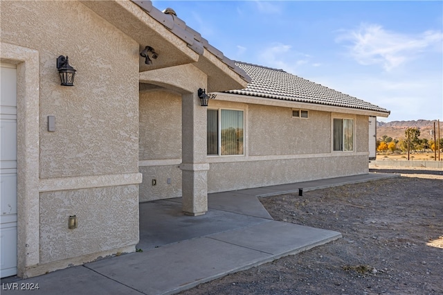 view of side of home with a mountain view