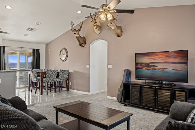 carpeted living room featuring vaulted ceiling and ceiling fan