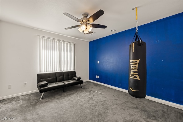 unfurnished room featuring ceiling fan and dark colored carpet