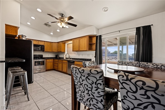 kitchen with black appliances, sink, vaulted ceiling, ceiling fan, and light tile patterned floors