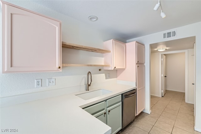 kitchen featuring sink, light tile patterned flooring, and stainless steel dishwasher