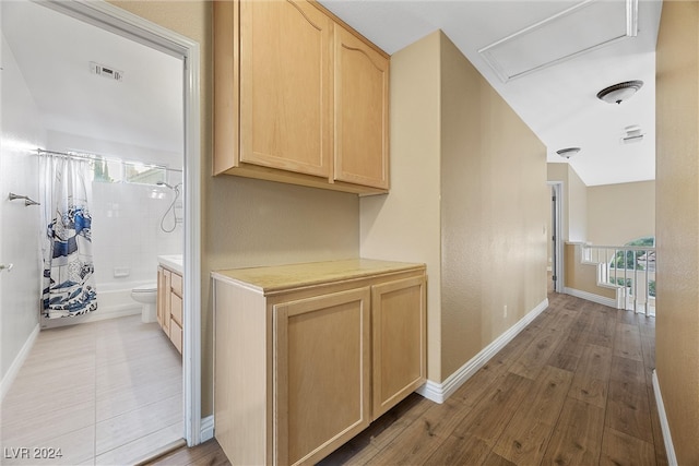 hallway with light hardwood / wood-style floors