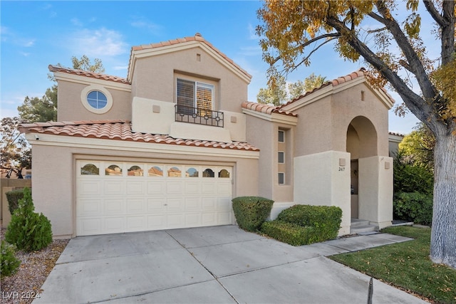 mediterranean / spanish-style house with a garage