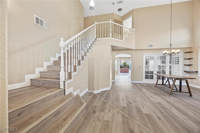 entryway featuring wood-type flooring and a high ceiling