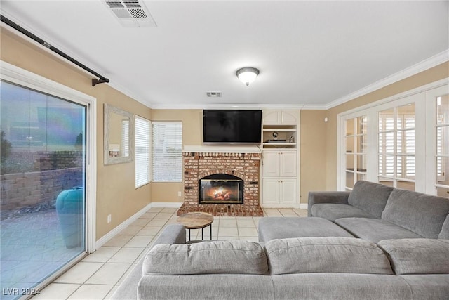 living room with a fireplace, light tile patterned floors, ornamental molding, and a healthy amount of sunlight