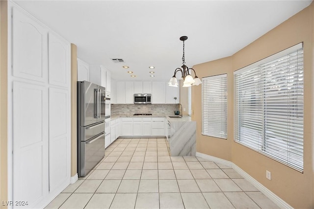 kitchen featuring white cabinets, stainless steel appliances, a wealth of natural light, and sink