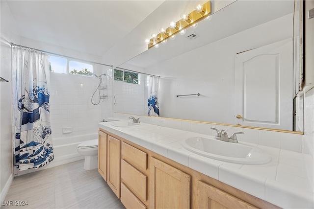 full bathroom with vanity, toilet, and shower / bath combo with shower curtain