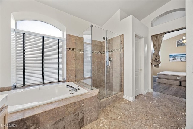 bathroom with vanity, lofted ceiling, and independent shower and bath