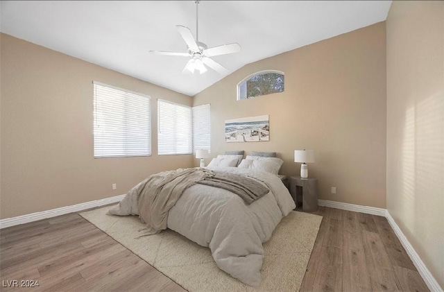 bedroom featuring ceiling fan, wood-type flooring, and vaulted ceiling