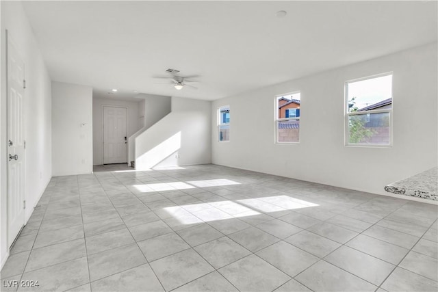 unfurnished room featuring ceiling fan and light tile patterned floors