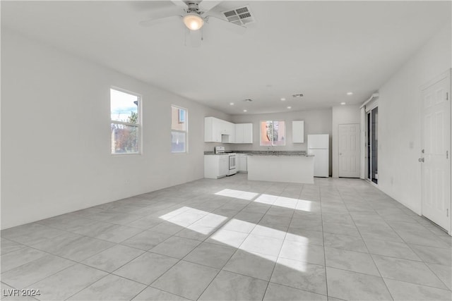 unfurnished living room with light tile patterned floors and ceiling fan