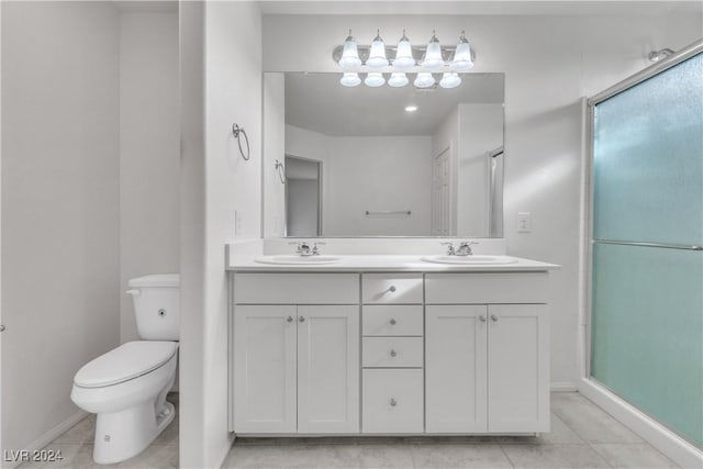 bathroom featuring walk in shower, tile patterned flooring, vanity, and toilet