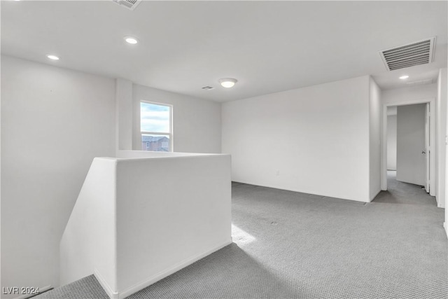 unfurnished room featuring light colored carpet