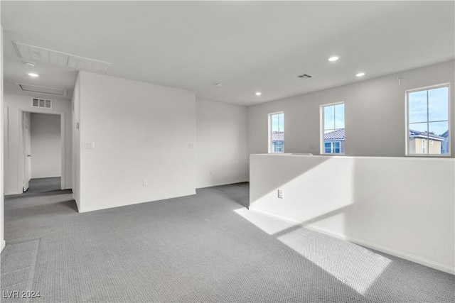 carpeted empty room featuring plenty of natural light