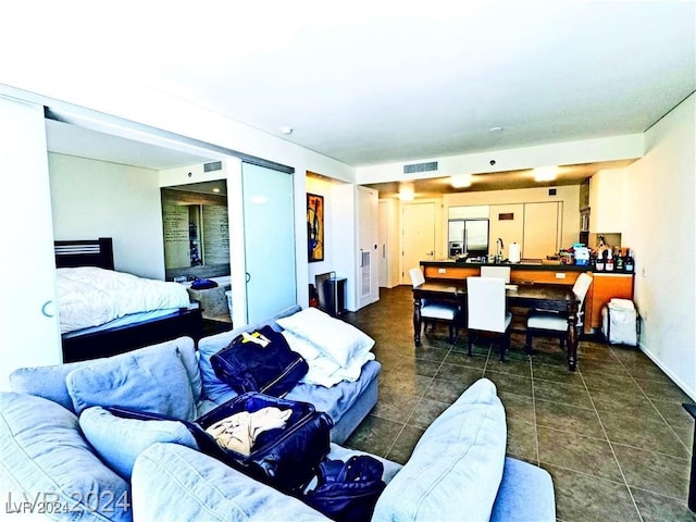 bedroom featuring stainless steel refrigerator with ice dispenser