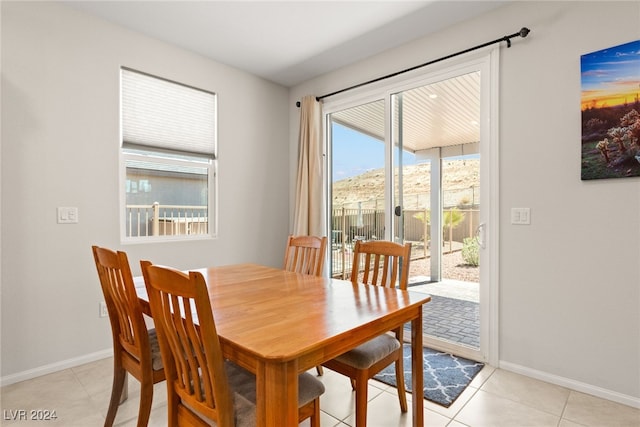 tiled dining room with a wealth of natural light