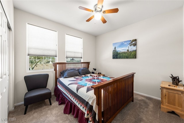 bedroom with dark colored carpet, a closet, and ceiling fan