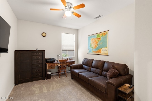 carpeted living room with ceiling fan