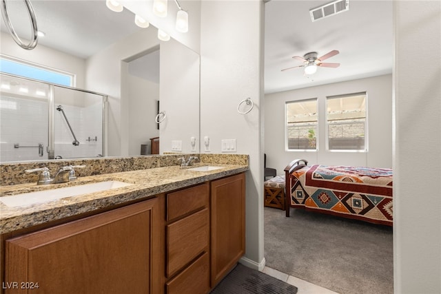 bathroom featuring ceiling fan, a healthy amount of sunlight, an enclosed shower, and vanity