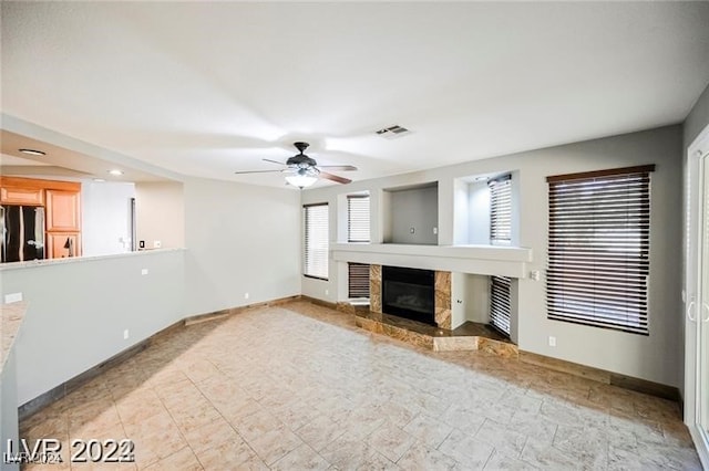 unfurnished living room featuring ceiling fan