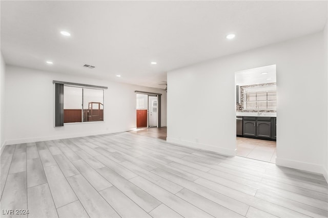 unfurnished room with light wood-type flooring