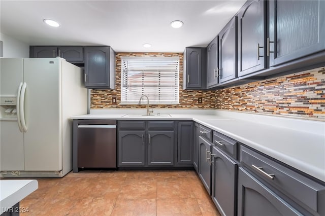 kitchen featuring tasteful backsplash, dishwasher, white fridge with ice dispenser, and sink