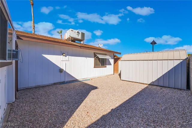 view of yard featuring a storage unit and cooling unit