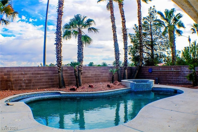 view of swimming pool with an in ground hot tub