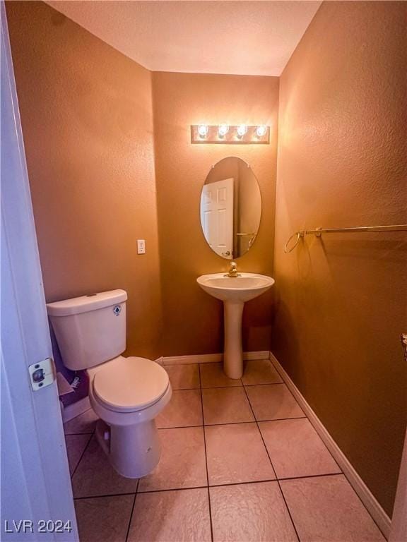 bathroom featuring tile patterned floors and toilet