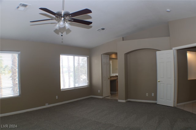 unfurnished room featuring ceiling fan, lofted ceiling, and carpet