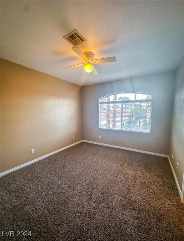 empty room featuring ceiling fan and carpet floors