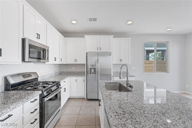 kitchen with white cabinets, light stone countertops, sink, and appliances with stainless steel finishes