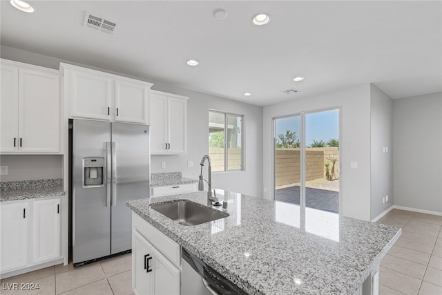 kitchen with white cabinets, a kitchen island with sink, sink, and appliances with stainless steel finishes