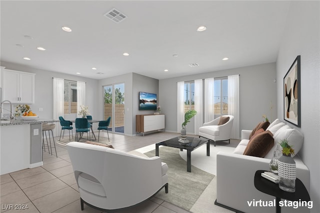 tiled living room featuring plenty of natural light and sink