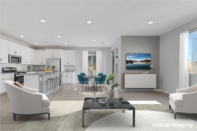 living room with plenty of natural light and light tile patterned flooring