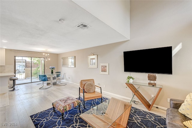 living room with a chandelier and wood-type flooring